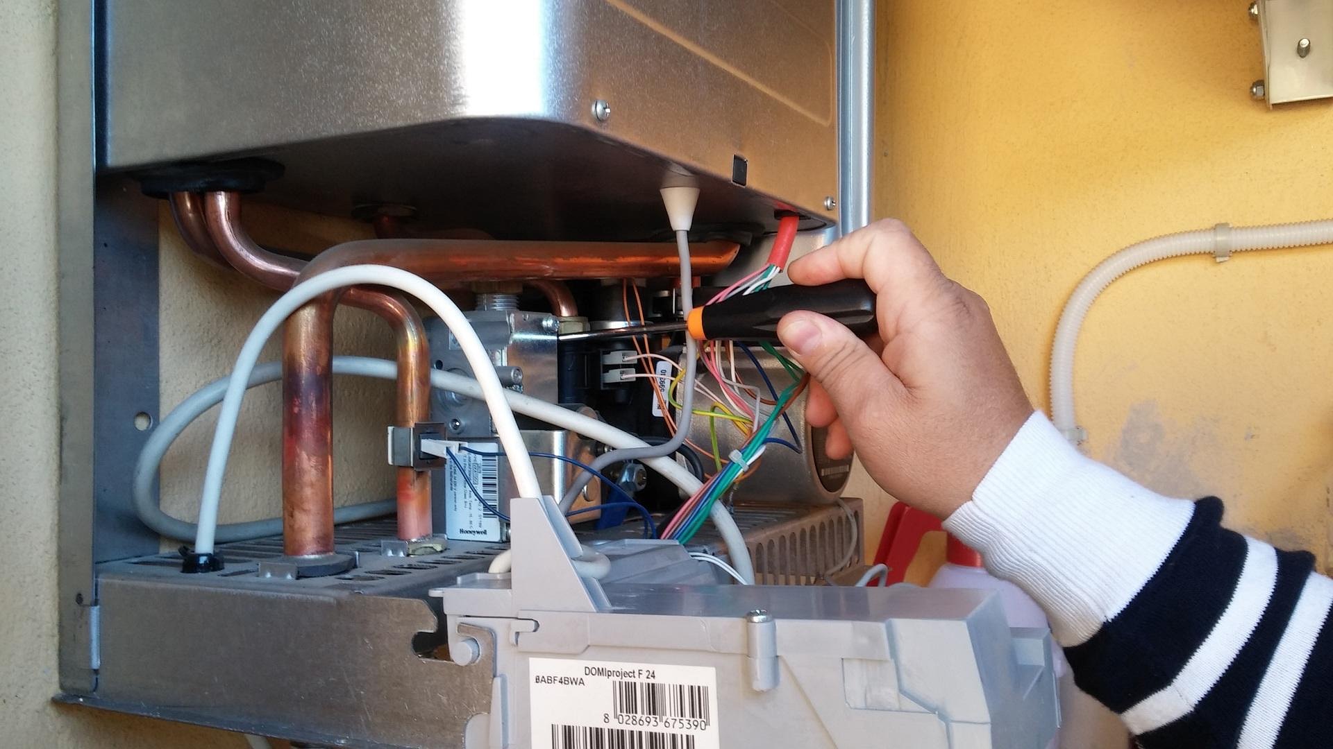 Gas Safe registered boiler engineer repairing a boiler in London